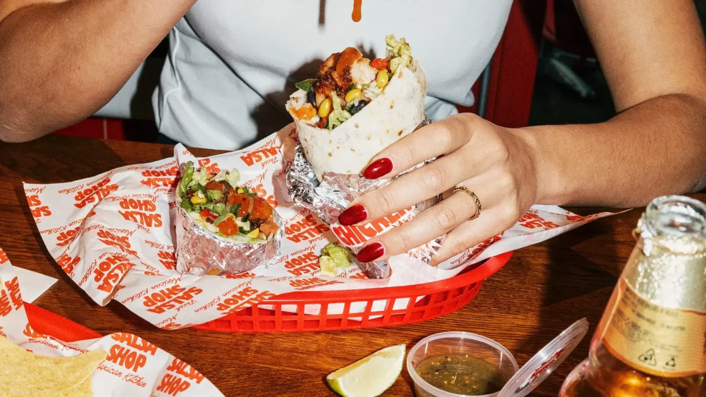 Friends digging into Salsa Shop burritos together