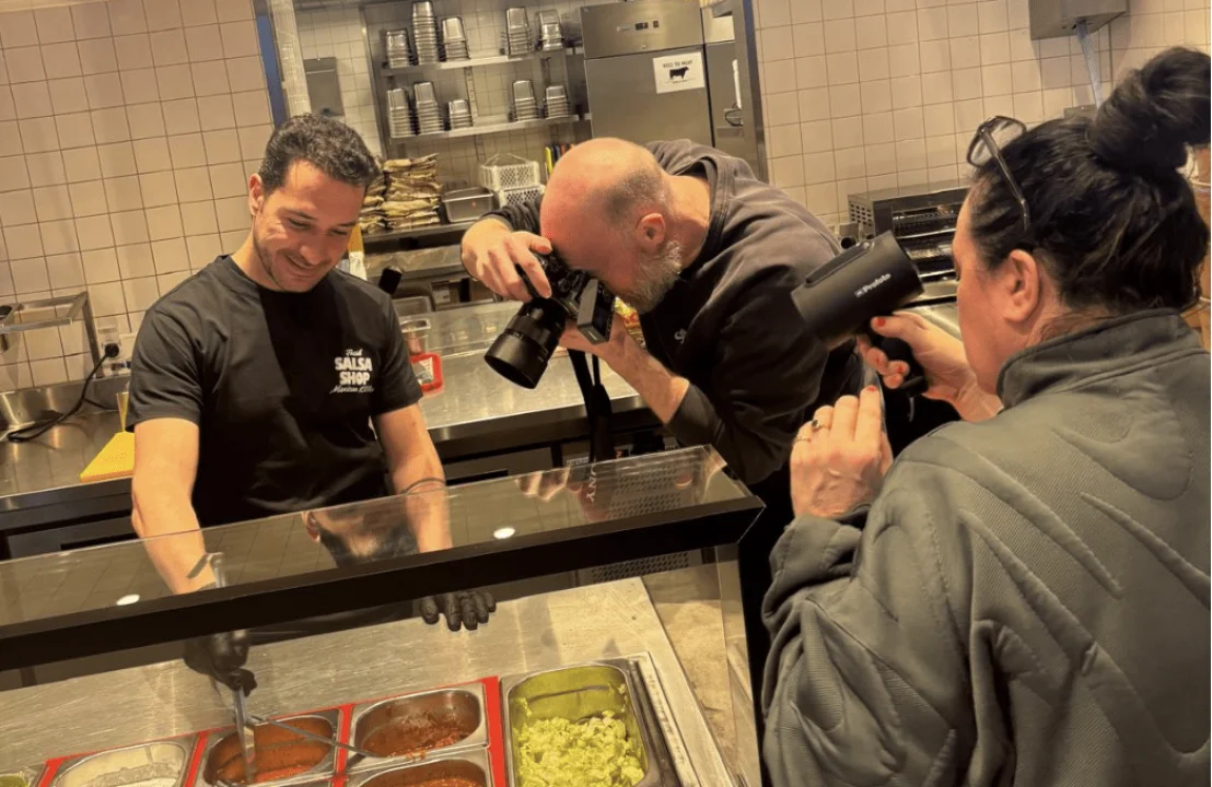 Salsa Shop team filming and photographing social media content inside the restaurant, capturing food preparation and daily activity during an in-house content shoot.