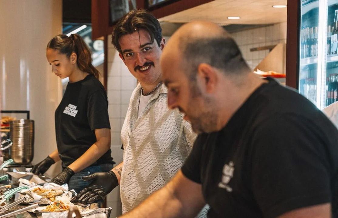 Salsa Shop team working behind the service line during a busy shift, preparing fresh Mexican meals as part of the 2025 highlights and year-in-review.
