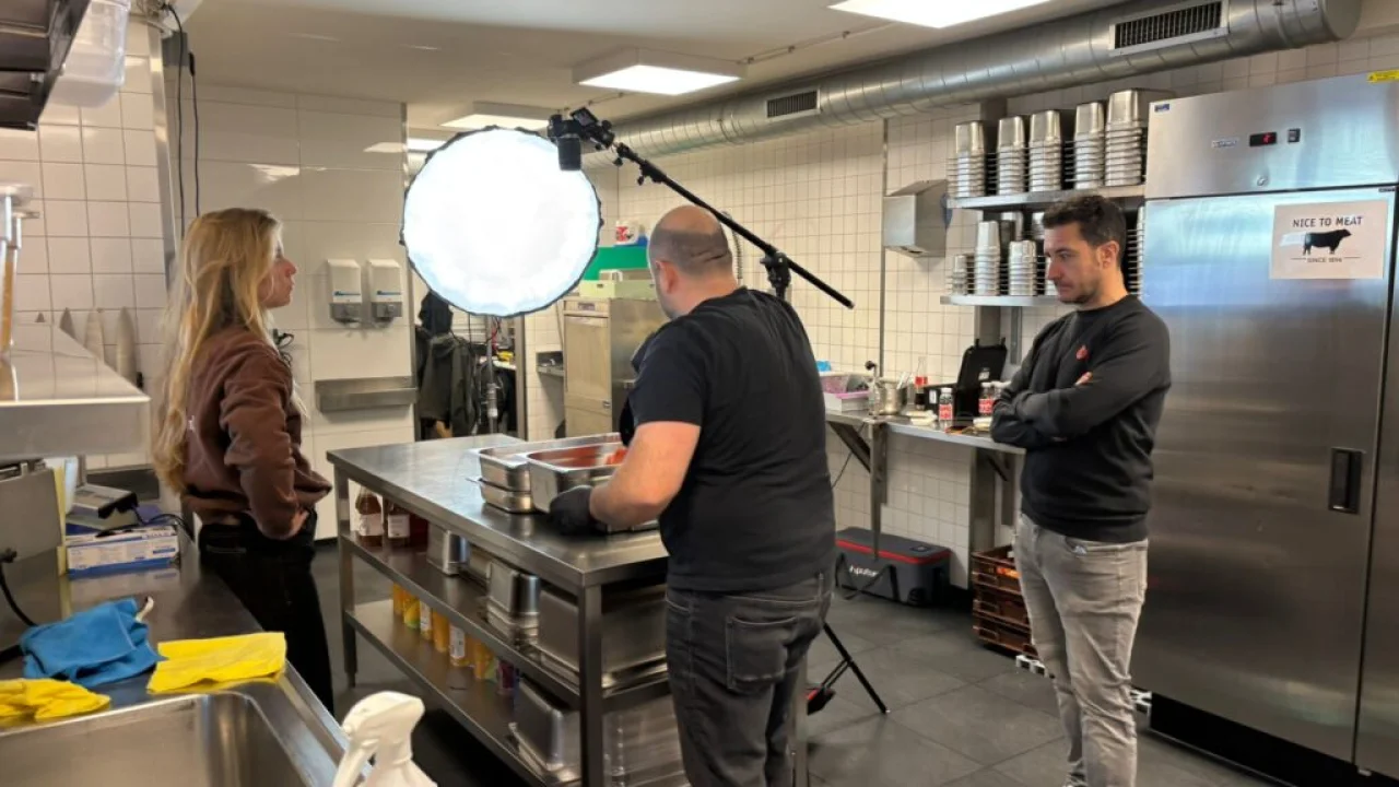 COO Alex and designer Loïs filming training instruction videos inside a Salsa Shop kitchen, capturing food preparation and workflow for staff training.