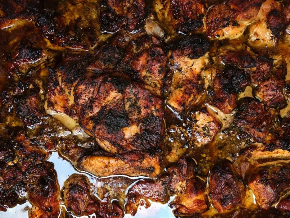Freshly roasted halal chicken coming out of the oven at Salsa Shop, prepared for use in burritos and bowls as part of the daily kitchen process.