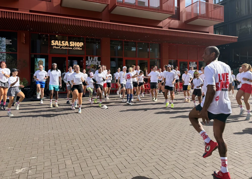 Around 70 runners warming up outside Salsa Shop NDSM before the latest 6K Live Saucy Run through Amsterdam Noord.