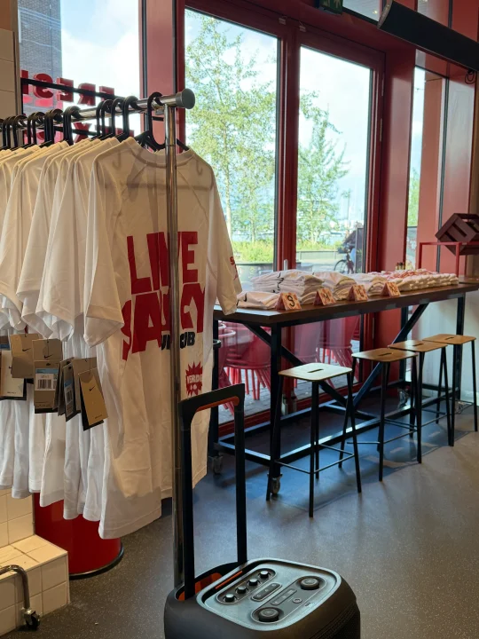 Live Saucy Run Club shirts and merchandise set up inside a Salsa Shop restaurant ahead of a community run.