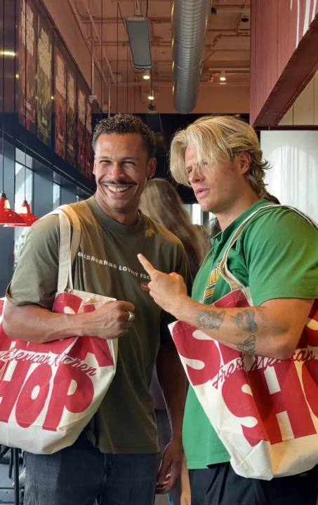 Two Salsa Shop creators holding up their goodie bags during a cooking workshop.